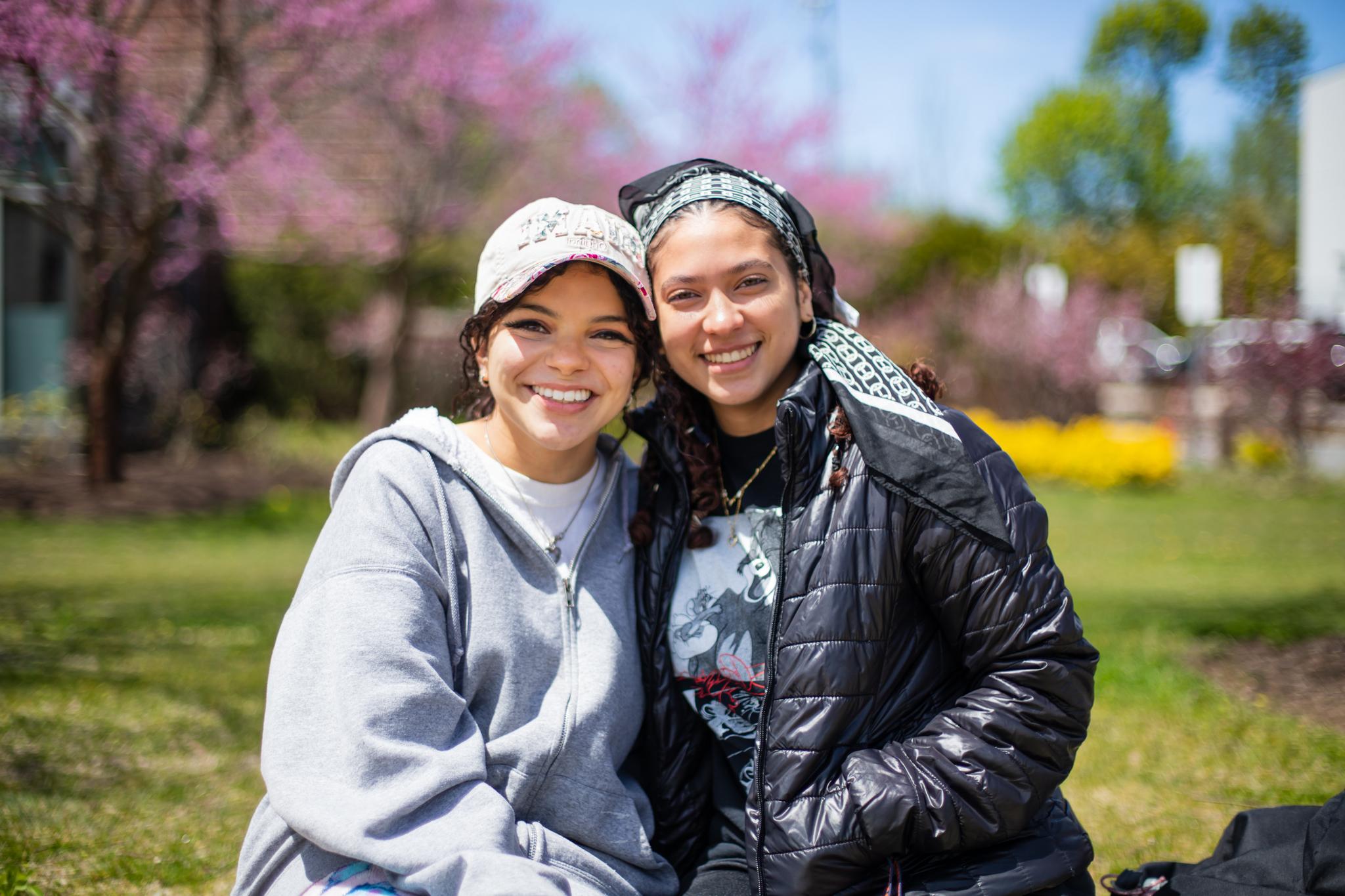 Two smiling students outside on Harrington campus