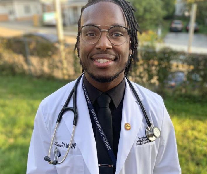Webb Camille '16 in a medical student coat and stethescope